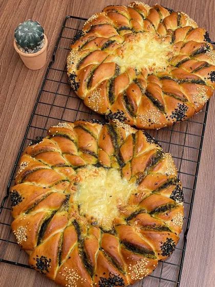 Two of my pesto cheese pull-apart breads, ready for a large order. The design looks intricate but it's all about sharing and pulling off a piece.