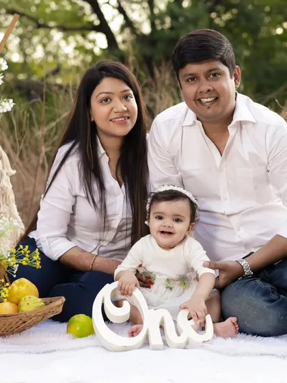 A perfect family portrait during their outdoor picnic session. Everyone is relaxed and smiling, creating a natural and beautiful memory.