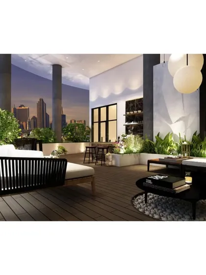 As evening sets in, this terrace transforms into a magical space with glowing spherical lights and illuminated planters, set against the city skyline.