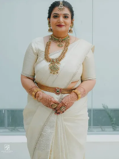 A beautiful client in a classic off-white Kanchipuram saree. Her custom blouse is simple and elegant, proving that timeless style is always the right choice.
