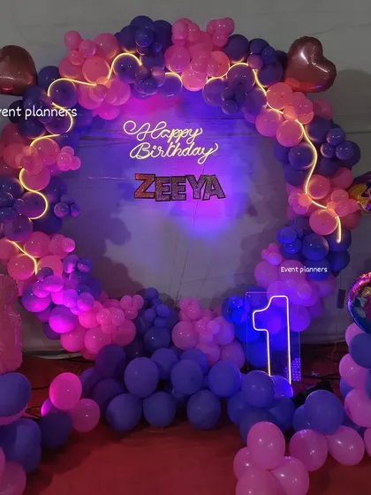 A closer view of the Barbie-themed birthday decor, highlighting the character cutout and foil heart balloons.