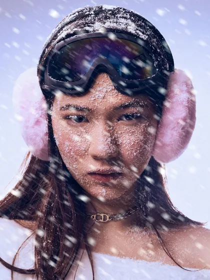 Creating a winter narrative. This look for a snow-themed editorial uses frosted skin, icy lashes, and winter accessories to build a story of couture meeting the cold.