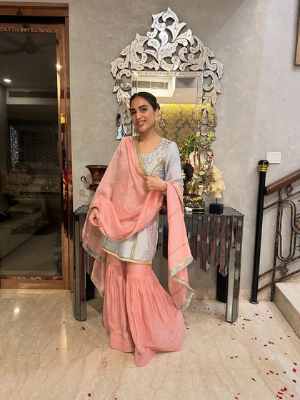 Another look at the blue and pink sharara set. The combination of a short kurta with flared pants is a modern take on traditional wear.