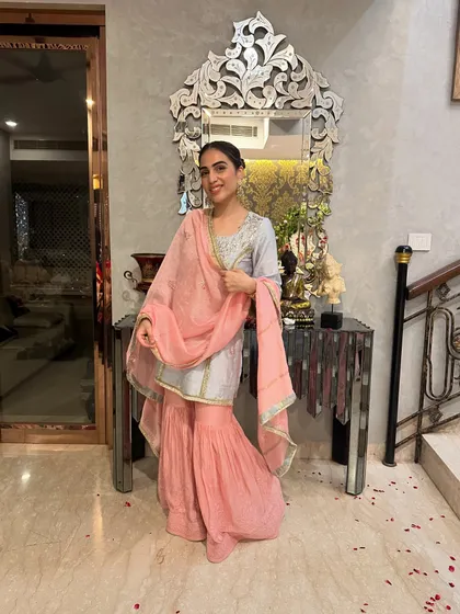Another look at the blue and pink sharara set. The combination of a short kurta with flared pants is a modern take on traditional wear.