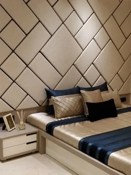 A geometric upholstered headboard that acts as a feature wall. This custom design involves creating and arranging individual panels to form a unique pattern, showcasing my ability to execute complex upholstery work.