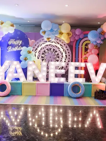 Your child is the star of the show. We design spectacular, personalized stages with marquee lights, like this stunning setup for Yaneev's 5th birthday carnival, creating the perfect centerpiece for the celebration.