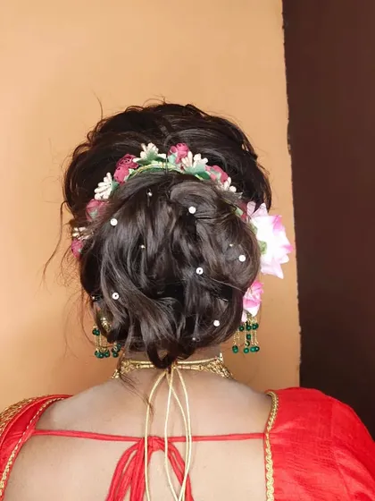 A messy, textured bun is a great choice for a sangeet or reception. I've adorned this one with flowers and pearl pins for a romantic, bohemian vibe.