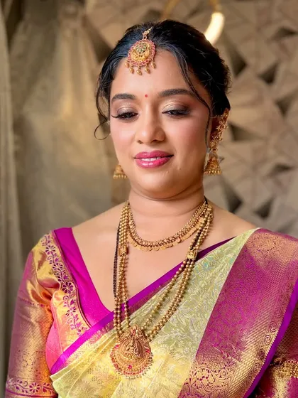 A detailed shot of the makeup, focusing on the soft, shimmery eye look and the beautifully defined brows.