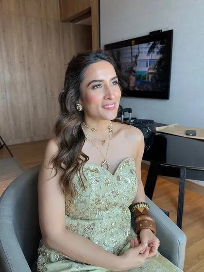 The client looking relaxed and happy before her event. This half-up style is effortlessly elegant and comfortable.