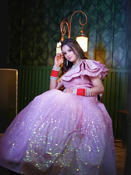 A seated pose that captures the gown's shimmer in a different light.