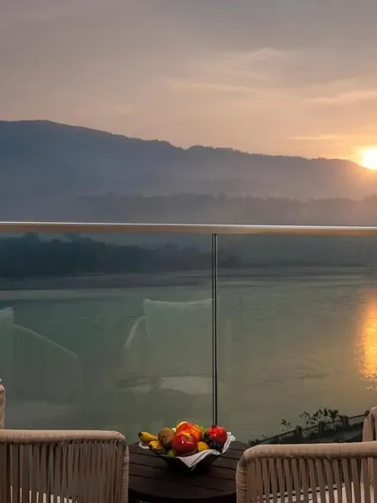 A serene balcony view from the Modi Yoga Retreat, a boutique hotel we designed in Rishikesh. The space is crafted to offer a peaceful escape, with unobstructed views of the Ganges and the surrounding mountains, perfectly embodying a place for relaxation and meditation.