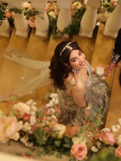 A dreamy, artistic shot of this beautiful look. The floral setting perfectly complements the ethereal vibe of her outfit and makeup.