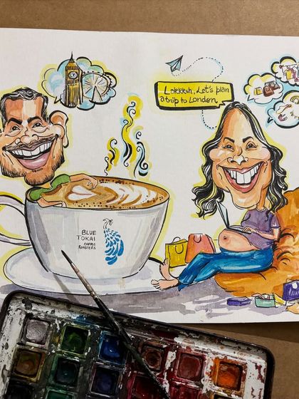 The finished watercolor painting for the expecting couple, shown with my paint palette. The colors are bright and cheerful, reflecting the happy theme of the artwork.