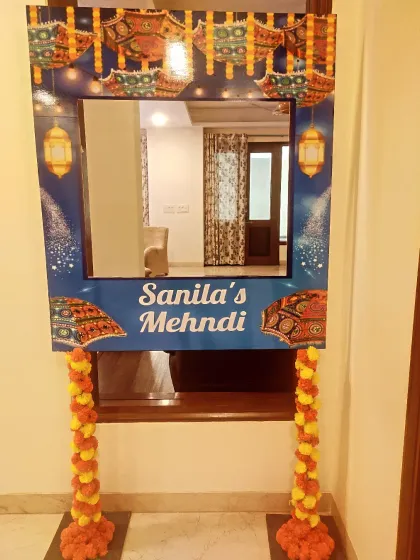 Personal touches make an event truly unique. I designed this custom photo booth frame for a Mehendi function, incorporating thematic graphics and the bride's name. It becomes a fun, interactive spot for guests to capture memories and adds a personalized element to the decor.