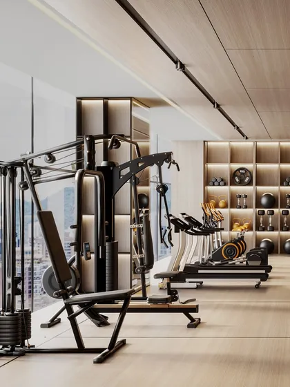 A view of the cardio and weight machines, with a large window offering a city view to make workouts more inspiring.