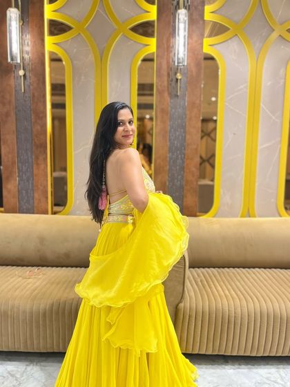 A side view of my yellow backless lehenga. I love how strength training has sculpted my back and shoulders.