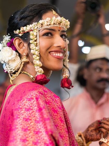 A beautiful bride adorned with floral jewelry for her wedding.