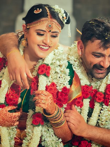 A candid and joyful moment between a couple during their wedding ceremony, sharing a happy embrace.