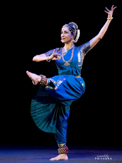 A classic Kuchipudi stance, with one leg raised and the body in a graceful tribhangi, or three-bend, posture.