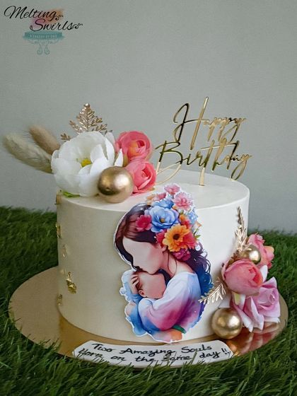 This lovely cake was for a new mom and baby who share a birthday. The design features a beautiful edible print of a mother and child, surrounded by flowers.