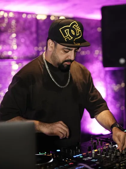 A close-up of me mixing at Kaze, with the signature purple lighting setting the mood.