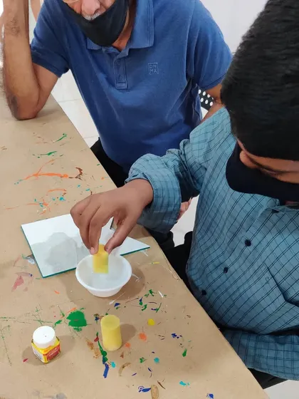 A father and son spending time together at the studio, working on a fun painting project during the holidays.