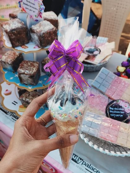 A fun treat for kids, this is my ice cream cakepop. It's a cake pop shaped like an ice cream cone, decorated with sprinkles and wrapped with a bow, perfect for parties.