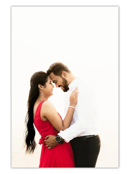 A high-key portrait using the bright sky as a clean backdrop, focusing entirely on the couple's happy and loving expressions.