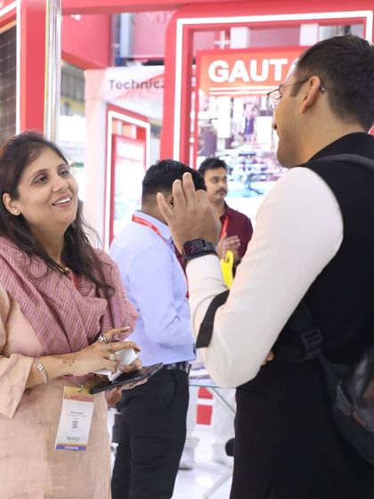A candid moment of interaction between our team and a visitor at the REI Expo, highlighting our friendly and professional approach.