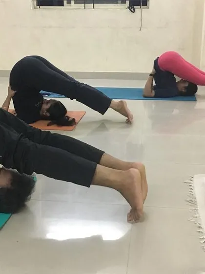 My students practicing Halasana (Plow Pose) during an in-studio class. This inversion is excellent for stretching the entire spine and calming the nervous system.