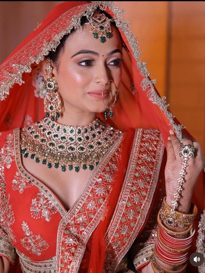 A full-length and a close-up shot of a bride in a stunning red lehenga. This provides a complete view of the outfit and the intricate makeup and jewellery.