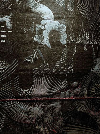 A close-up of the woven fabric from our 'Gothilicious' installation. The design is based on stylized tattoo art, meandering across the black surface to express mystery, complexity, and beauty.