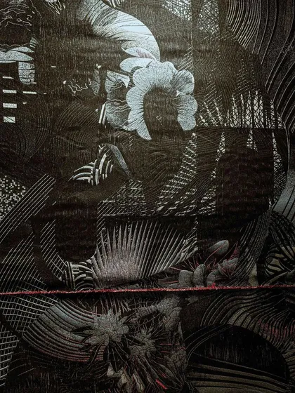 A close-up of the woven fabric from our 'Gothilicious' installation. The design is based on stylized tattoo art, meandering across the black surface to express mystery, complexity, and beauty.