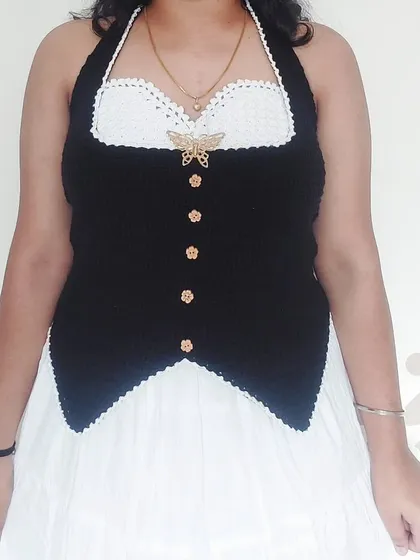 A full front view of the Belladonna Top, showcasing the button details and elegant shape.