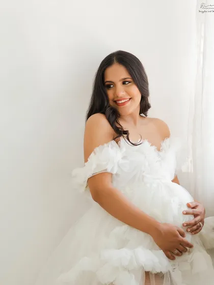 There is something so angelic about a mother-to-be in a white ruffled gown. This portrait is all about softness, light, and the pure joy of pregnancy.