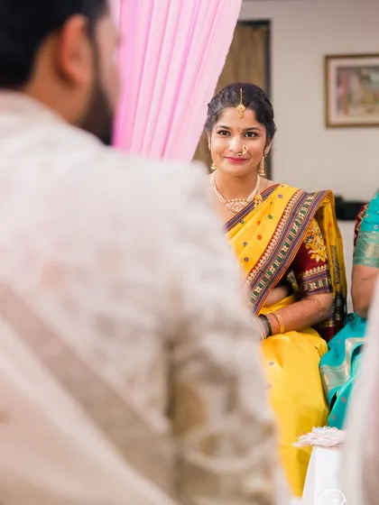 An over-the-shoulder shot of the bride looking at her groom during the ceremony.