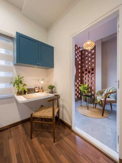 A view from the bedroom looking out onto the jali-screened balcony. This connection ensures the bedroom benefits from natural light and ventilation, blurring the lines between indoors and out.