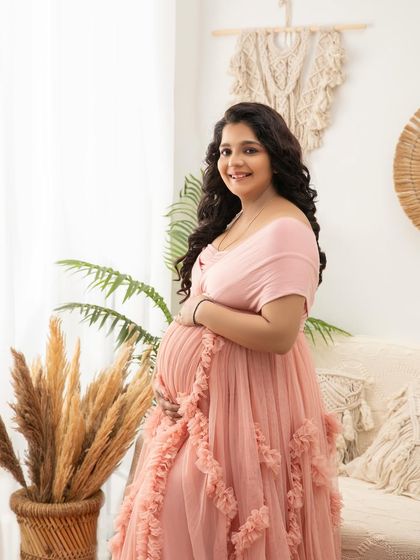 A lovely close-up portrait in the pink gown, capturing a bright and happy smile. The natural elements in the background add texture and interest.