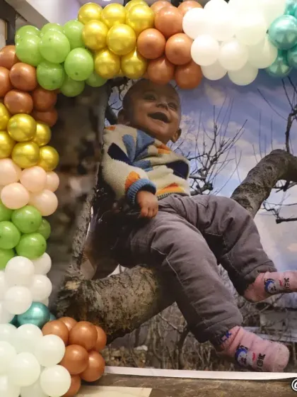 A customized selfie point is a great addition to any party. This one features a large picture of the birthday boy, framed by a colorful balloon arch, creating a perfect spot for guests to take photos.