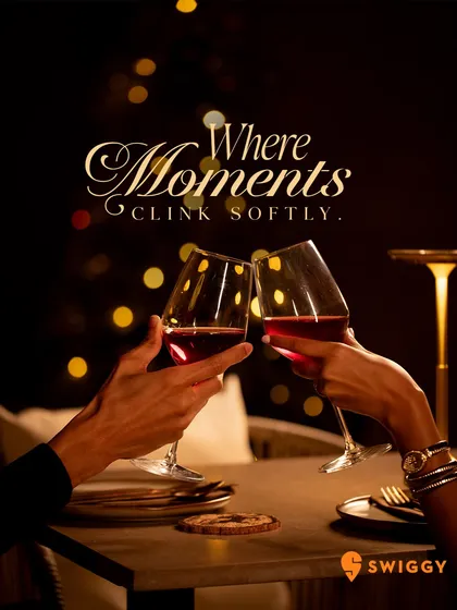 Moments here clink softly. A toast between two people marks the beginning of a memory, set against the soft, ambient glow of the dining room.