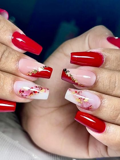 Festive glam, sealed with a shine. This bold red set is perfect for a party, with accent nails featuring a mix of red, white, and gold glitter flakes.