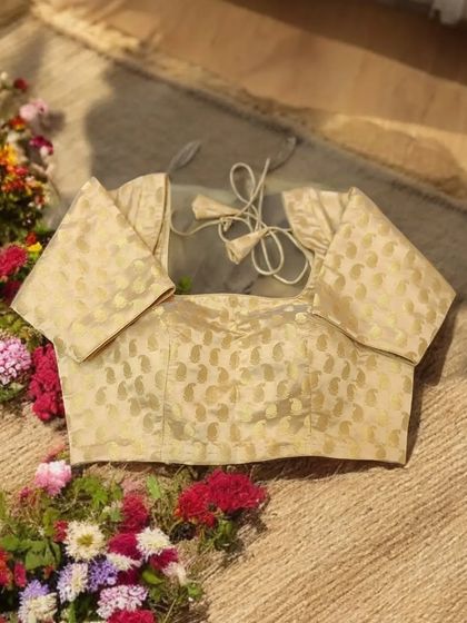A gold brocade blouse is a versatile and elegant must-have in any wardrobe. Its luxurious hue pairs beautifully with a variety of saree colors for a timelessly elegant look.