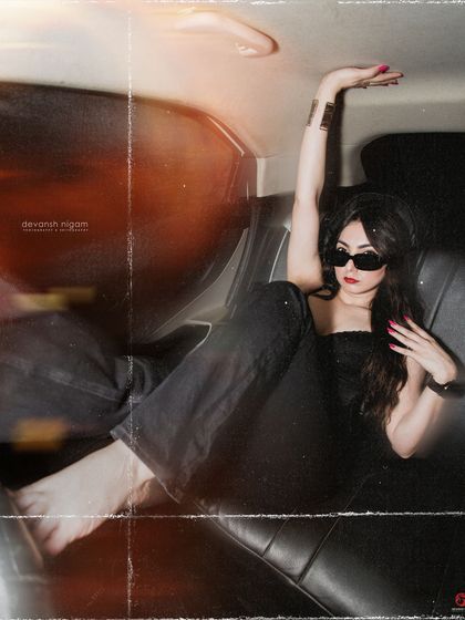 A full-length reclining pose in the car, creating a dynamic and interesting composition.