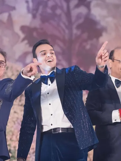 The men of the family, spanning generations, dancing together. We choreograph for all ages, making it a true family affair.