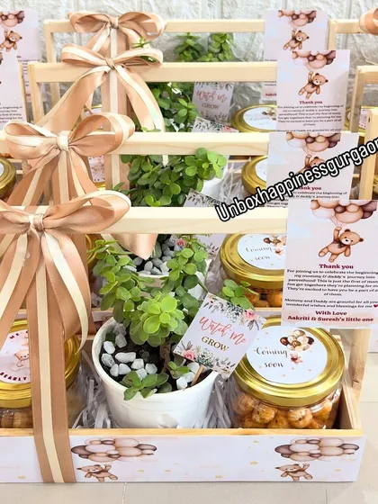 A beautiful display of teddy bear themed baby shower return gifts. The neutral color palette makes them perfect for any shower, and each basket includes a plant and treats.