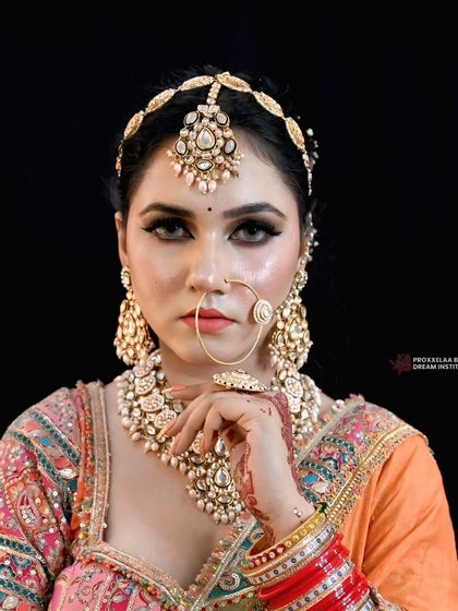 Radiating elegance in a beautiful orange and pink ensemble. This look is all about soft glam, with a focus on captivating eyes and luminous skin.