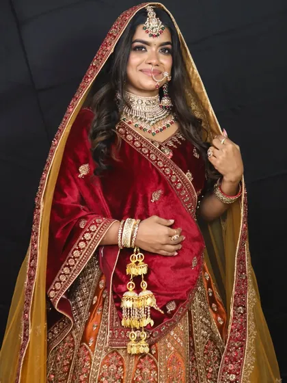 The complete look with the velvet lehenga and contrasting yellow dupatta, adorned with traditional kalire.