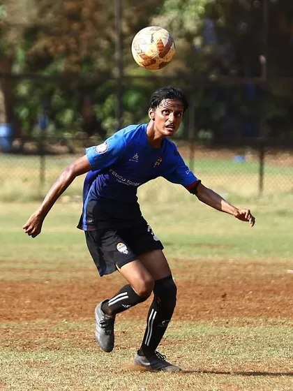 A player controls a high ball with his chest, a demonstration of technical skill.