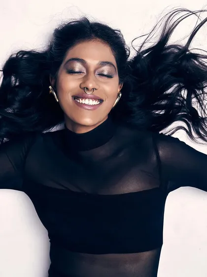 A creative shot with a focus on expression and mood. The metallic, smokey eye makeup is the centerpiece of this look, creating a dreamy and ethereal vibe.