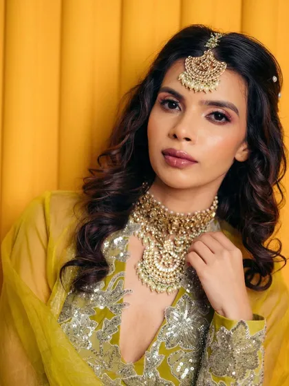Another angle of the soft pink Mehendi look. The makeup is blended seamlessly to create a romantic and ethereal vibe for the bride-to-be.